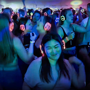 A crowd of people wearing Silent Disco headphones.