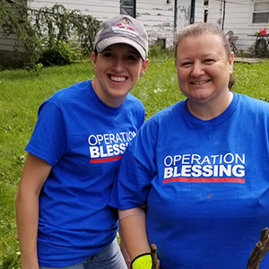 Two people volunteering with Operation Blessing.