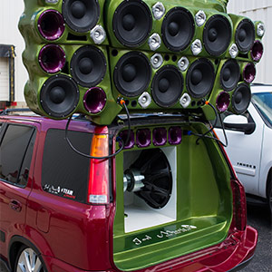 Wild elaborate custom car audio build attached to the top rear of a vehicle.